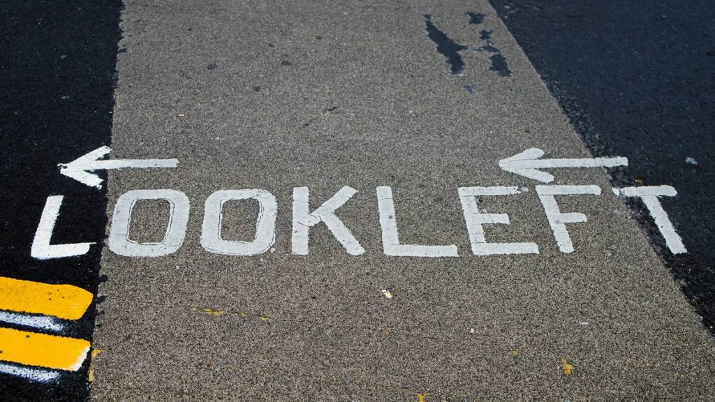 The text "look left" is written on the road